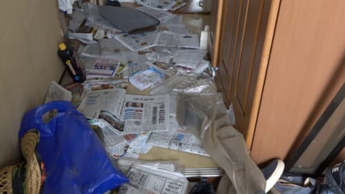 新聞紙が散らばる玄関